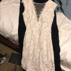 Whitish tan lace dress with an open back.